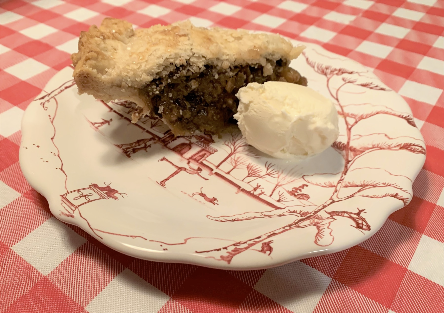 A slice of homemade mincemeat pie with ice cream.